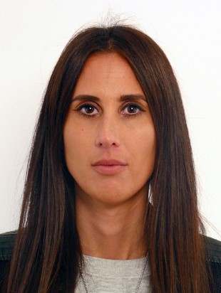 Portrait of a woman with long dark brown hair and brown eyes.